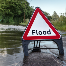 Flood sign in on road where there is surface water